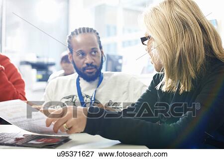 Female lecturer and college students having informal discussion in classroom View Large Photo Image Stock Photo - Female lecturer and college students having informal discussion in classroom. Fotosearch