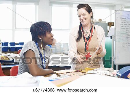 Female lecturer chatting to student in textile class View Large Photo Image Stock Photo - Female lecturer chatting to student in textile class. Fotosearch