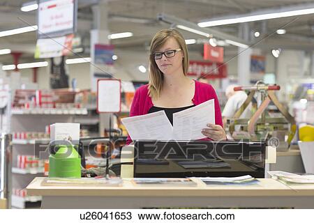 Female shop assistant checking orders in hardware store View Large Photo Image Stock Image - Female shop assistant checking orders in hardware store. Fotosearch
