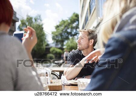 Friends having lunch by canal View Large Photo Image Stock Image - Friends having lunch by canal. Fotosearch