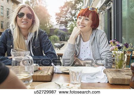 Friends having lunch by canal View Large Photo Image Stock Photo - Friends having lunch by canal. Fotosearch