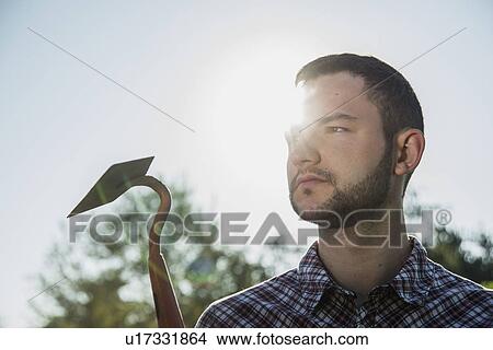 Gardener holding hoe View Large Photo Image Picture - Gardener holding hoe. Fotosearch