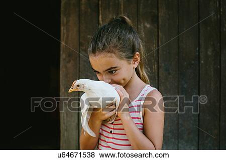 Stock Photo - Girl holding hen. Fotosearch