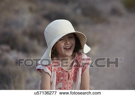 Stock Photo - Girl in sunhat laughing, Almeria, Andalusia, Spain. Fotosearch