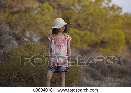 Girl in sunhat standing on hillside, Almeria, Andalusia, Spain View Large Photo Image Stock Image - Girl in sunhat standing on hillside, Almeria, Andalusia, Spain. Fotosearch