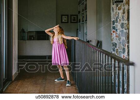 Girl on landing with hand on forehead View Large Photo Image Stock Photo - Girl on landing with hand on forehead. Fotosearch