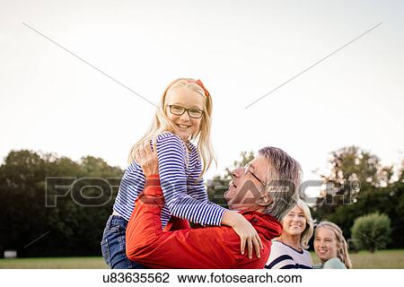 Grandfather lifting granddaughter View Large Photo Image Stock Image - Grandfather lifting granddaughter. Fotosearch