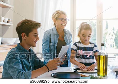 Grandmother and grandchildren preparing food View Large Photo Image Stock Photography - Grandmother and grandchildren preparing food. Fotosearch