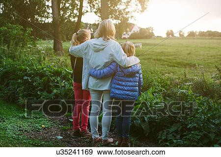 Grandmother and granddaughters looking at field View Large Photo Image Stock Photo - Grandmother and granddaughters looking at field. Fotosearch