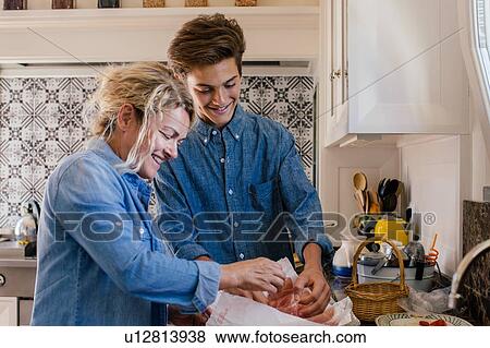Grandmother and grandson preparing food in kitchen View Large Photo Image Stock Photo - Grandmother and grandson preparing food in kitchen. Fotosearch