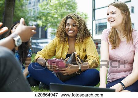 Group of college friends sitting chatting View Large Photo Image Stock Photo - Group of college friends sitting chatting. Fotosearch