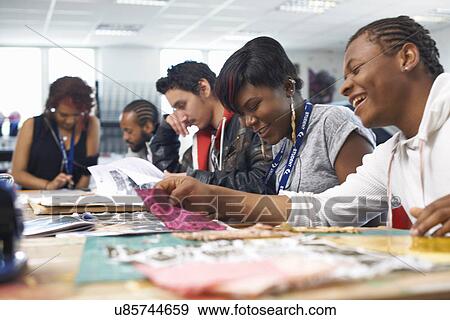 Stock Photo - Group of students at table in textile class. Fotosearch