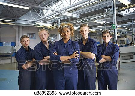 Stock Image - Group portrait of students in college workshop. Fotosearch