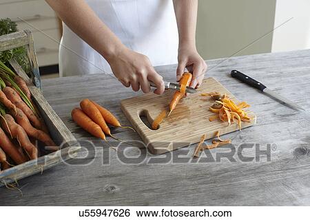 Hands of teenage girl peeling carrots on kitchen counter View Large Photo Image Stock Photograph - Hands of teenage girl peeling carrots on kitchen counter. Fotosearch