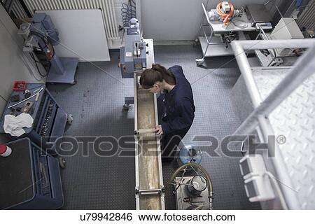 High angle view of female engineer checking manufacturing machinery View Large Photo Image Stock Photograph - High angle view of female engineer checking manufacturing machinery. Fotosearch