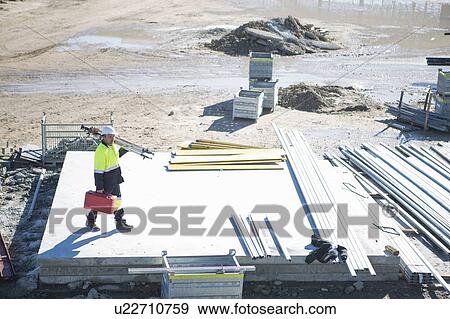 High angle view of surveyor carrying case and tripod on construction site View Large Photo Image Stock Photo - High angle view of surveyor carrying case and tripod on construction site. Fotosearch