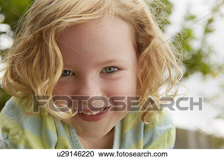 Stock Image - Low angle close up portrait of cute girl. Fotosearch