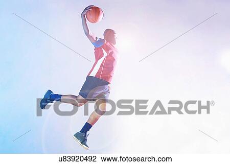 Male basketball player throwing ball View Large Photo Image Stock Image - Male basketball player throwing ball. Fotosearch