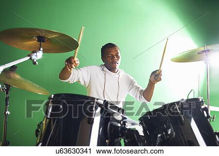 Male student playing drums in college music classroom View Large Photo Image Stock Image - Male student playing drums in college music classroom. Fotosearch