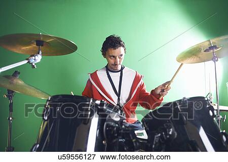 Male student playing drums in college music room View Large Photo Image Stock Photo - Male student playing drums in college music room. Fotosearch