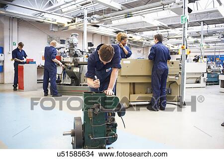 Picture - Male student sharpening tools in college workshop. Fotosearch