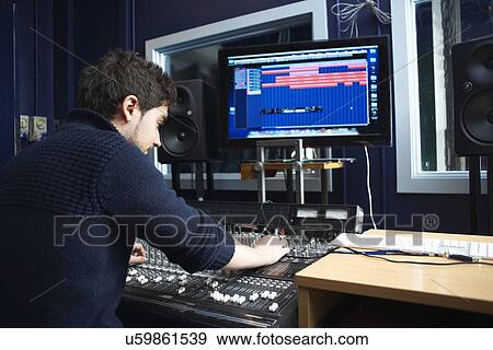 Male student using sound mixing equipment in college music booth View Large Photo Image Stock Photo - Male student using sound mixing equipment in college music booth. Fotosearch