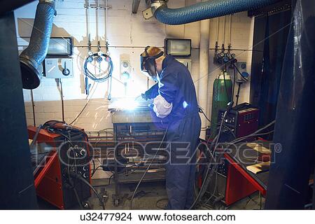 Male student welder welding in college workshop View Large Photo Image Picture - Male student welder welding in college workshop. Fotosearch