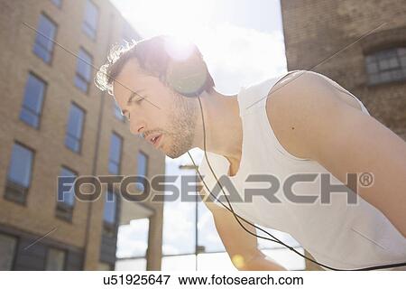 Stock Photo - Man taking break at exercise. Fotosearch