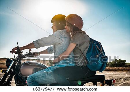 Mid adult couple motorcycling on arid plain, Cagliari, Sardinia, Italy View Large Photo Image Stock Photo - Mid adult couple motorcycling on arid plain, Cagliari, Sardinia, Italy. Fotosearch