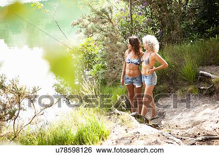 Stock Photograph - Mother and daughter enjoying nature, The Blue Pool, Wareham, Dorset, United Kingdom. Fotosearch