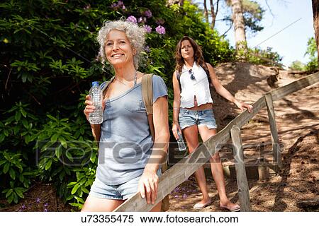 Stock Photography - Mother and daughter on footpath, The Blue Pool, Wareham, Dorset, United Kingdom. Fotosearch