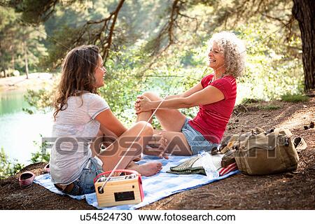 Mother and daughter on picnic blanket by the Blue Pool, Wareham, Dorset, United Kingdom View Large Photo Image Stock Image - Mother and daughter on picnic blanket by the Blue Pool, Wareham, Dorset, United Kingdom. Fotosearch