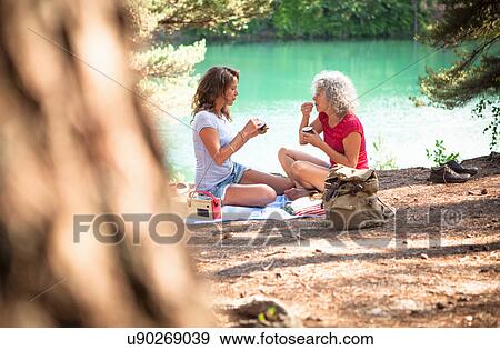 Mother and daughter on picnic blanket by the Blue Pool, Wareham, Dorset, United Kingdom View Large Photo Image Stock Photo - Mother and daughter on picnic blanket by the Blue Pool, Wareham, Dorset, United Kingdom. Fotosearch