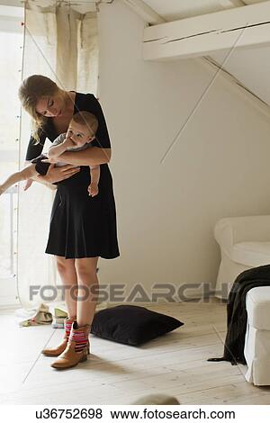 Stock Photo - Mother holding baby boy. Fotosearch