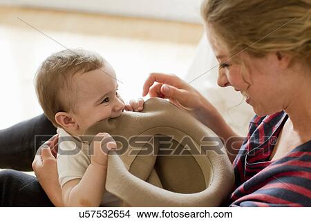 Picture - Mother playing with baby boy. Fotosearch