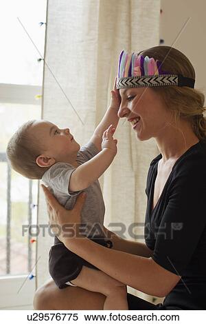 Stock Photography - Mother playing with baby boy. Fotosearch