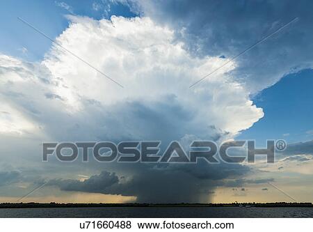 Stock Photo - Ominous storm cloud over lake, Sneek, Friesland, the Netherlands. Fotosearch