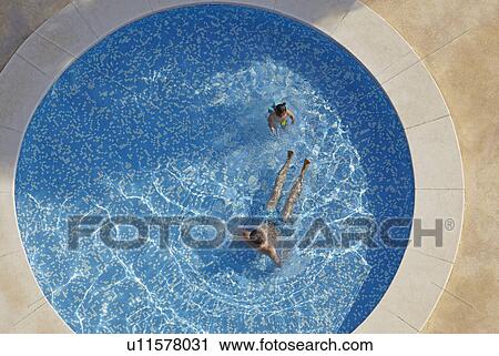 Overhead view of man and toddler daughter in swimming pool View Large Photo Image Stock Image - Overhead view of man and toddler daughter in swimming pool. Fotosearch