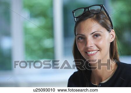 Stock Image - Portrait of businesswoman in office. Fotosearch