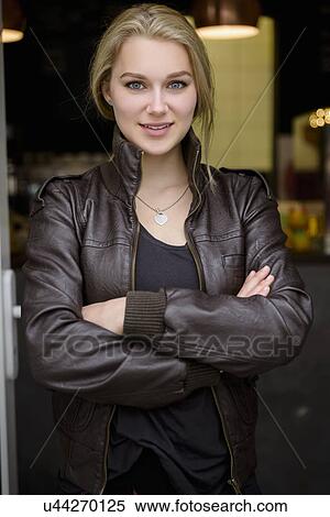Portrait of confident young woman in cafe doorway View Large Photo Image Stock Photography - Portrait of confident young woman in cafe doorway. Fotosearch