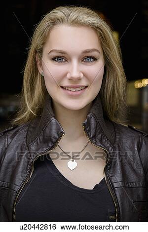 Stock Photograph - Portrait of confident young woman outside cafe. Fotosearch