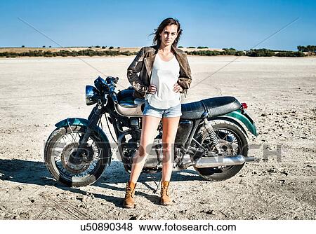 Portrait of female motorcyclist on arid plain, Cagliari, Sardinia, Italy View Large Photo Image Stock Photo - Portrait of female motorcyclist on arid plain, Cagliari, Sardinia, Italy. Fotosearch