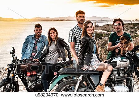 Portrait of five motorcycling friends on coast at sunset, Cagliari, Sardinia, Italy View Large Photo Image Stock Image - Portrait of five motorcycling friends on coast at sunset, Cagliari, Sardinia, Italy. Fotosearch