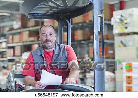 Portrait of forklift truck driver in hardware store warehouse View Large Photo Image Stock Photo - Portrait of forklift truck driver in hardware store warehouse. Fotosearch