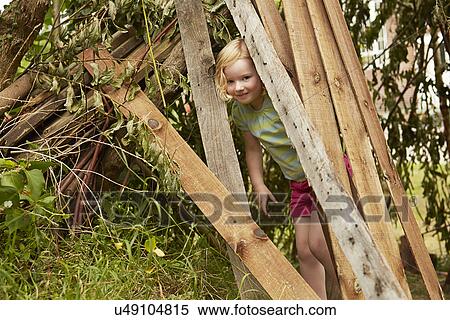 Portrait of girl hiding in garden den View Large Photo Image Stock Photography - Portrait of girl hiding in garden den. Fotosearch