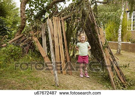 Portrait of girl with hands on hips in garden den View Large Photo Image Stock Photo - Portrait of girl with hands on hips in garden den. Fotosearch