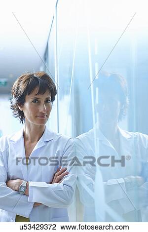 Portrait of mature businesswoman leaning against glass wall in office View Large Photo Image Stock Image - Portrait of mature businesswoman leaning against glass wall in office. Fotosearch