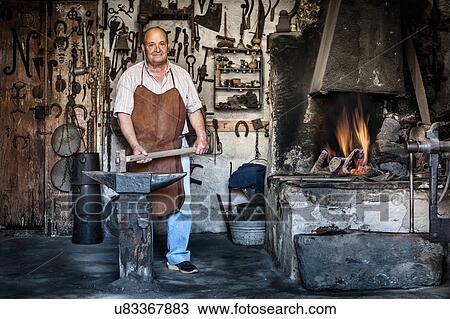 Stock Image - Portrait of senior male blacksmith in traditional workshop, Cagliari, Sardinia, Italy. Fotosearch