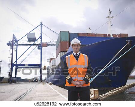 Portrait of ship's captain standing in front of container ship View Large Photo Image Stock Image - Portrait of ship's captain standing in front of container ship. Fotosearch