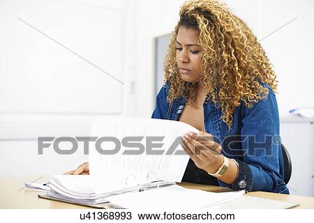Stock Image - Portrait of teenage female student in college classroom. Fotosearch